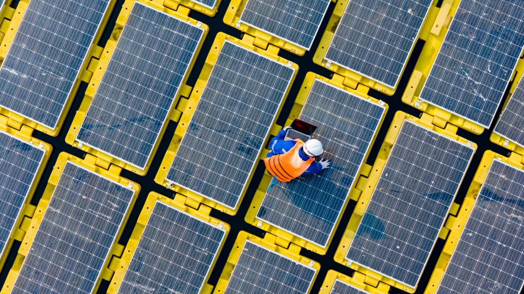 Floating solar panels providing renewable energy. Aerial view floating on solar cells and